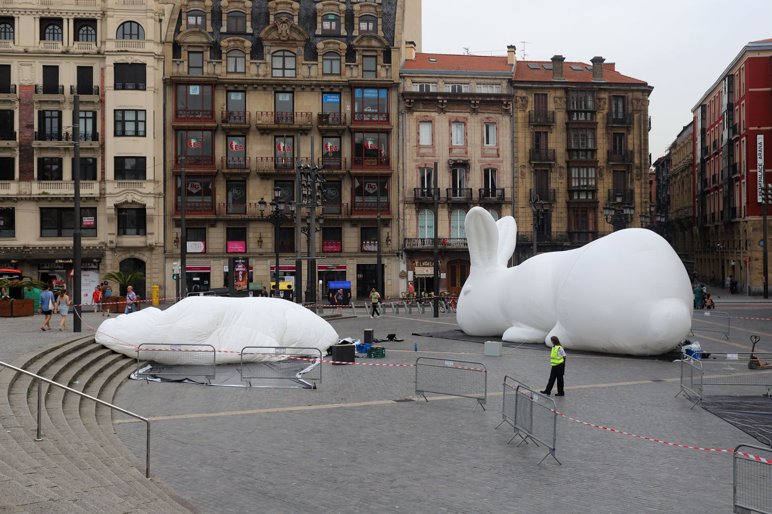 One fully and one semi-deflated huge white rabbits